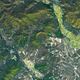 A green crescent at center is the Yilan Crater from above, surrounded by wildnerness and agricultural fields.